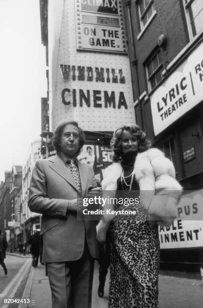 British nightclub owner and publisher Paul Raymond with his girlfriend, actress and glamour model Fiona Richmond outside the Windmill Cinema in...