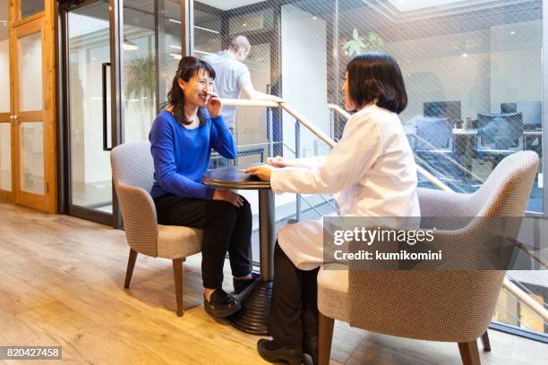 doctor and patient at clinic - japan and medical and hospital stock pictures, royalty-free photos & images