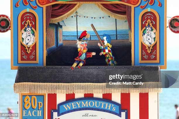 Punch and Judy puppets battle it out during a show on Weymouth beach on July 23, 2008 in Weymouth, England. With the majority of schools breaking up...