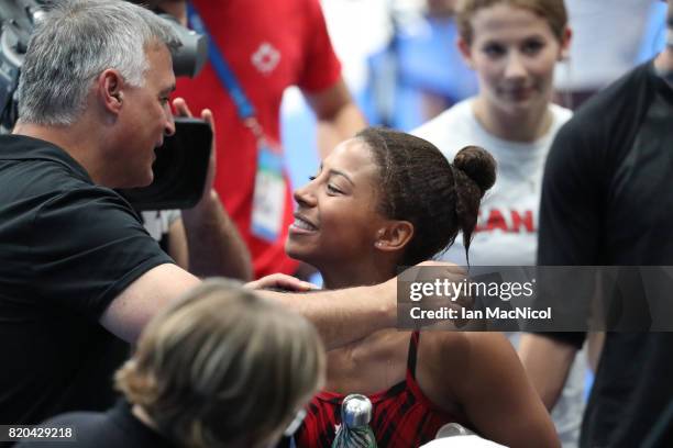 Jennifer Able of Canada is congratulated by team mates after winning bronze in the Women's 3m Springboard at the Duna Arena on day eight of the FINA...