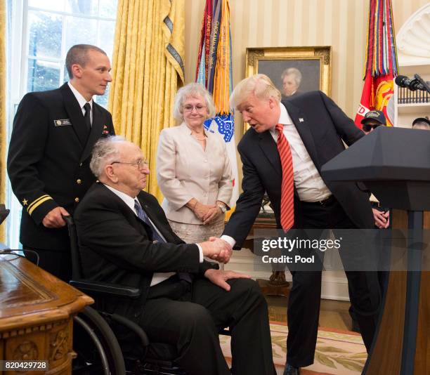 President Donald J. Trump shakes the hand of Lauren Bruner as USS Arizona survivors visit the White House on July 21, 2017 in Washington, DC.