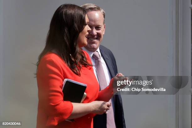 White House Press Secretary Sean Spicer and Principal Deputy Press Secretary Sarah Huckabee Sanders walk out of the White House July 21, 2017 in...