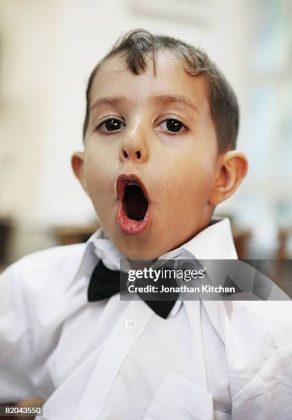 young boy in bow tie singing - boy singing stock-fotos und bilder