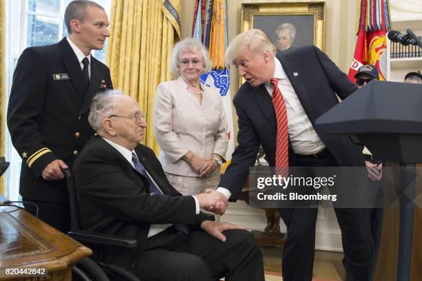 President Donald Trump, right, shakes hands with Lauren Bruner, Donald Stratton, a survivor from the USS Arizona, during a meeting at the White House...