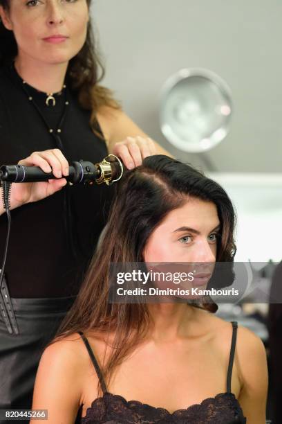 Model prepares backstage during the SWIMMIAMI Hammock 2018 Collection fashion show at WET Deck at W South Beach on July 21, 2017 in Miami Beach,...