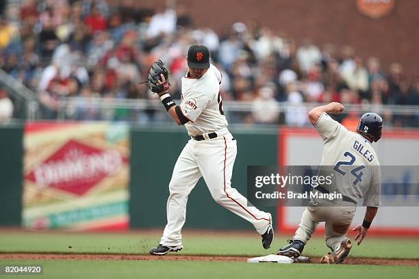 Travis Denker of the San Francisco Giants catches the ball to force out Brian Giles of the San Diego Padres during the game at AT&T Park on May 31,...