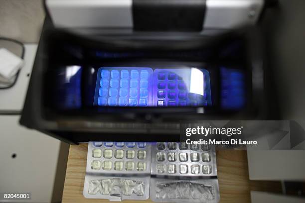 Employee test for the bacteriological content in a sample of water at the water testing laboratory, at the Camp Bastion Water Bottling Plant on July...