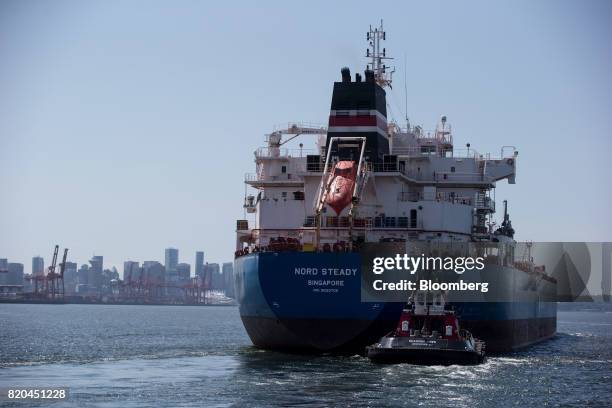 The Nord Steady oil and chemical tanker is guided by tugboats out of the Port of Vancouver in Vancouver, British Columbia, Canada, on Tuesday, July...