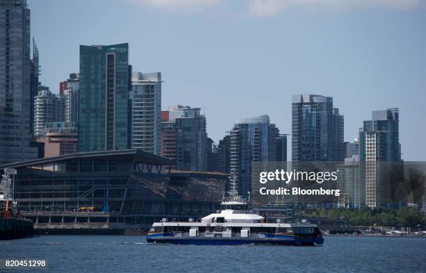 Seabus commuter vessel travels on the harbour as condo towers are seen in the skyline in Vancouver in Vancouver, British Columbia, Canada, on...