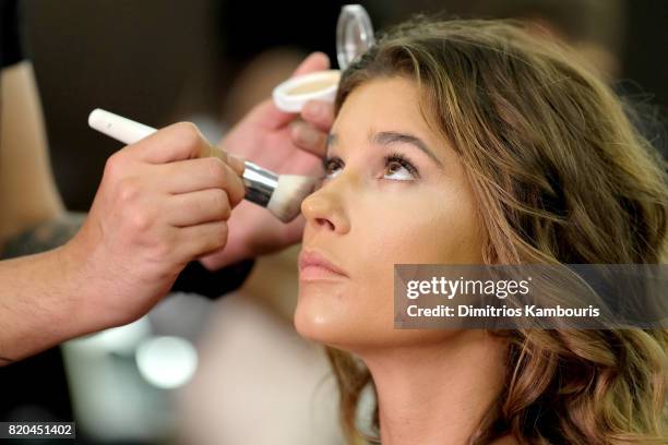 Model prepares backstage during the SWIMMIAMI Hammock 2018 Collection fashion show at WET Deck at W South Beach on July 21, 2017 in Miami Beach,...