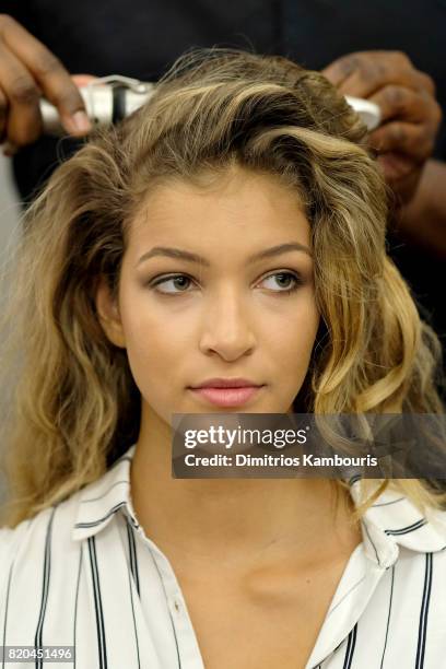 Model prepares backstage during the SWIMMIAMI Hammock 2018 Collection fashion show at WET Deck at W South Beach on July 21, 2017 in Miami Beach,...