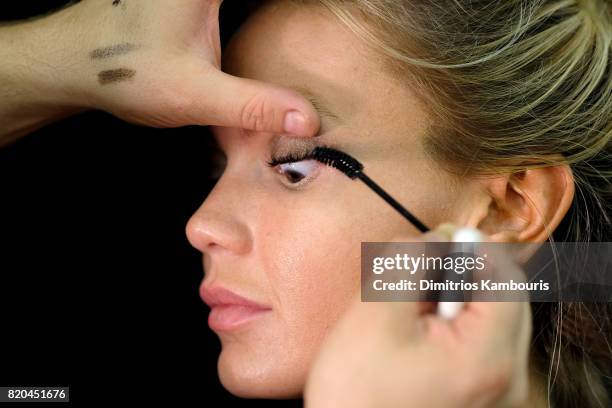 Model prepares backstage during the SWIMMIAMI Hammock 2018 Collection fashion show at WET Deck at W South Beach on July 21, 2017 in Miami Beach,...