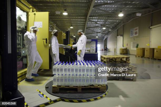 Employees work at a manufacturing plant at the Camp Bastion Water Bottling Plant on July 21, 2008 at the British Army base in Camp Bastion in the...