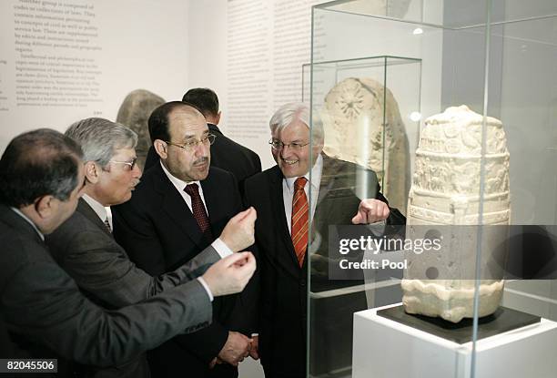 Iraqi Prime Minister Nouri al-Maliki and German Foreign Minister Frank-Walter Steinmeier look at an exhibit during their visit to a special...