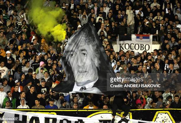 Supporters of Partizan Belgrade wave a flag with a photo of Radovan Karadzic during a friendly soccer match between Partizan Belgrade and Olympic...