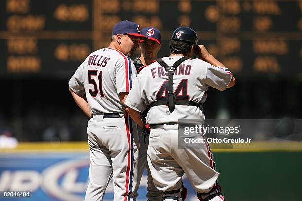 Pitching coach Carl Willis meets with Jeremy Sowers and catcher Sal Fasano of the Cleveland Indians during the game against the Seattle Mariners on...