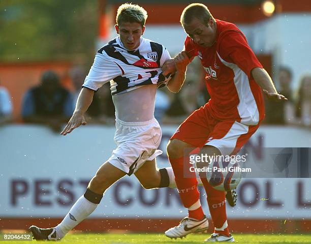 James Hancox of West Bromwich Albion battles for the ball with Paul Connor of Cheltenham Town during the Pre Season Friendly match between Cheltenham...