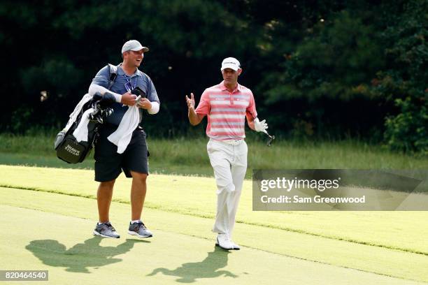 Shawn Stefani of the United States walks with substitue caddie Mike Wolfe during the second round of the Barbasol Championship at the Robert Trent...