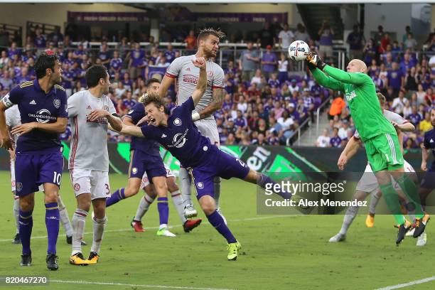 Goalkeeper Brad Guzan of Atlanta United makes a save against Jonathan Spector of Orlando City SC during a MLS soccer match between Atlanta United FC...