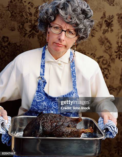 woman with burnt turkey - burnt cooking stock pictures, royalty-free photos & images