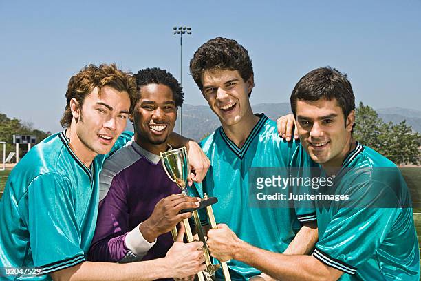 winning soccer team with trophy - football team trophy stock pictures, royalty-free photos & images