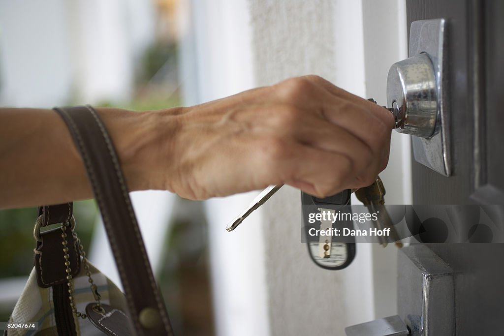 Key Unlocking Someone Hand With Keys Unlocking Door High-Res Stock Photo - Getty Images