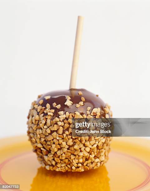 caramel apple with nuts - caramel block stock pictures, royalty-free photos & images