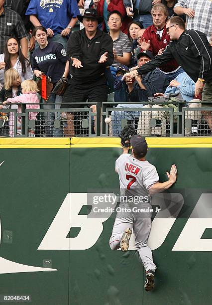 Right fielder J.D. Drew of the Boston Red Sox leaps at the wall for a two run homer by Jose Vidro of the Seattle Mariners on July 23, 2008 at Safeco...