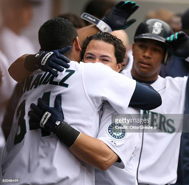 Jose Vidro of the Seattle Mariners is congratulated by starting pitcher Felix Hernandez after hitting a two run homer against the Boston Red Sox on...