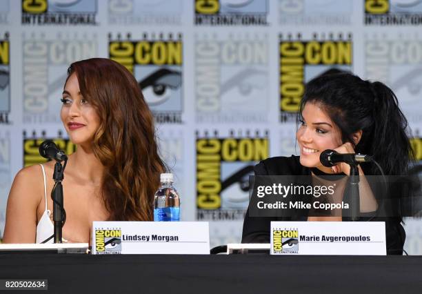 Lindsey Morgan and Marie Avgeropoulos speak onstage at Comic-Con International 2017 "The 100" panel at San Diego Convention Center on July 21, 2017...