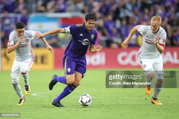 Kaka of Orlando City SC splits Miguel Almiron of Atlanta United and Jeff Larentowicz of Atlanta United during a MLS soccer match between Atlanta...
