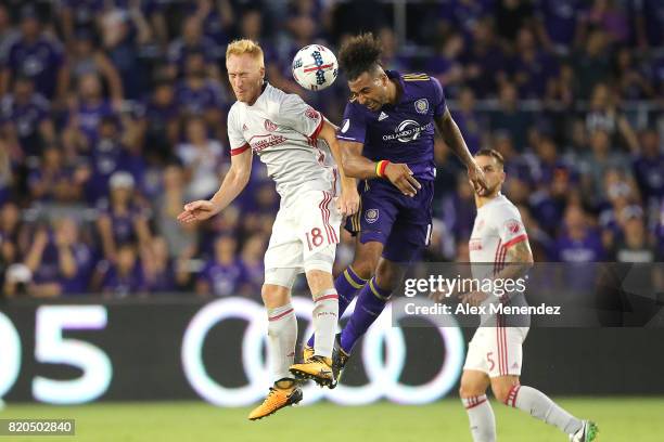 Jeff Larentowicz of Atlanta United and Giles Barnes of Orlando City SC leap for the ball during a MLS soccer match between Atlanta United FC and the...