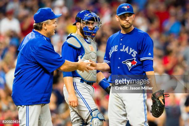 Manager John Gibbons removes starting pitcher Marco Estrada of the Toronto Blue Jays from the game during the fifth inning against the Cleveland...