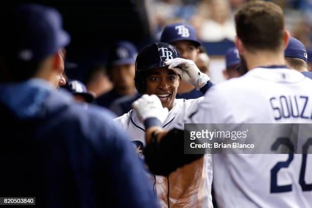 Mallex Smith of the Tampa Bay Rays celebrates with teammates, including Steven Souza Jr. #20, in the dugout after hitting a home run off of pitcher...