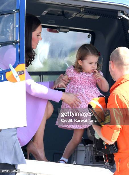 Princess Charlotte of Cambridge and Catherine, Duchess of Cambridge view helicopter models H145 and H135 before departing from Hamburg airport on the...