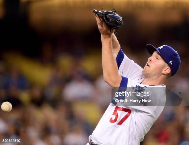 Alex Wood of the Los Angeles Dodgers drops a pop fly hit by Jaime Garcia of the Atlanta Braves, allowing two runs to score, to trail the Braves 4-0...