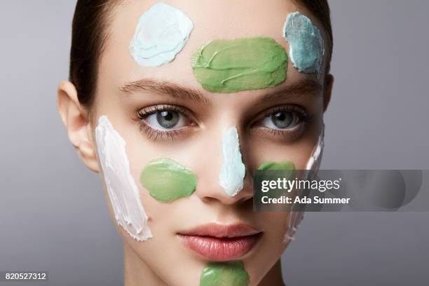 close up shot of a beautiful woman with facial detox mask on her face - exfoliation face stock pictures, royalty-free photos & images