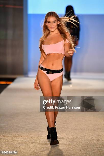 Model walks the runway during the SWIMMIAMI KAOHS 2018 Collection fashion show at WET Deck at W South Beach on July 21, 2017 in Miami Beach, Florida.