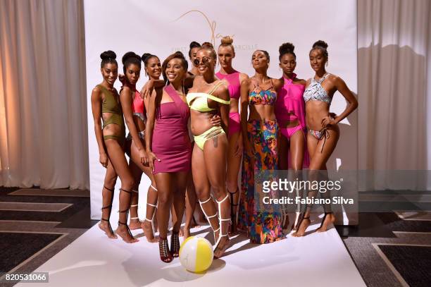 Keva Johnson and Eva Marcille pose with models during the Keva J Swimwear S/S 2018 fashion show at Loews Miami Beach Hotel on July 21, 2017 in Miami...