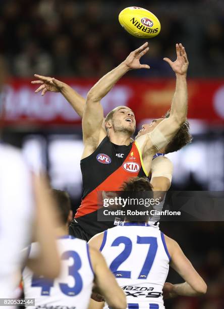 David Zaharakis of the Bombers and Ryan Clarke of the Kangaroos compete for the ball during the round 18 AFL match between the Essendon Bombers and...