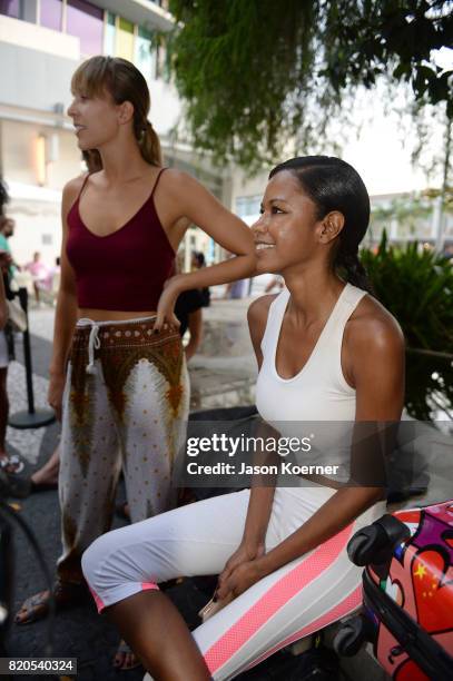 Models prepare at the "Tankovitz on Lincoln Road" event presented by DIVE Swim Week on July 21, 2017 in Miami, Florida.