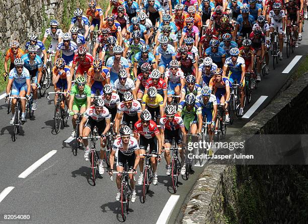 Race leader Carlos Sastre of Spain and team CSC Saxo Bank, wearing the yellow jersey, rides amid the peloton during stage eighteen of the 2008 Tour...