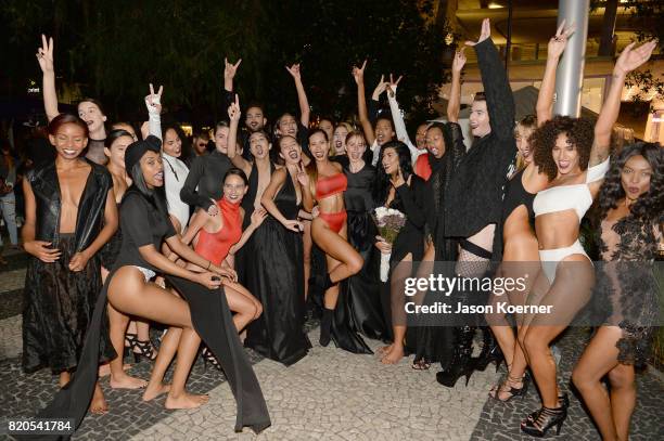 Designer Andrea Tankovitz poses with models at the "Tankovitz on Lincoln Road" event presented by DIVE Swim Week on July 21, 2017 in Miami, Florida.