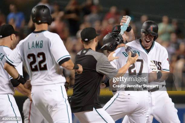 Brandon Drury of the Arizona Diamondbacks celebrates with Chris Owings and Paul Goldschmidt after hitting a walk off single against the Washington...