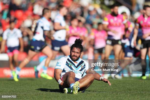 Konrad Hurrell of the Titans lies on the pitch injured during the round 20 NRL match between the Penrith Panthers and the Gold Coast Titans at Pepper...