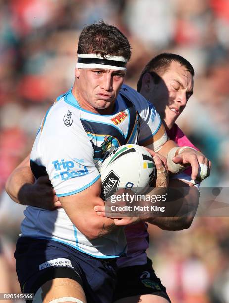 Jarrod Wallace of the Titans is tackled by Isaah Yeo of the Panthers during the round 20 NRL match between the Penrith Panthers and the Gold Coast...