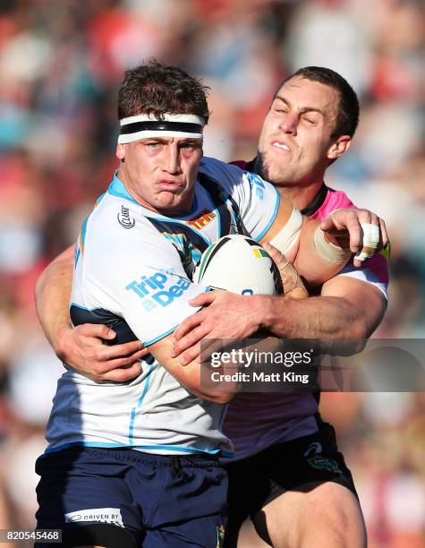 Jarrod Wallace of the Titans is tackled by Isaah Yeo of the Panthers during the round 20 NRL match between the Penrith Panthers and the Gold Coast...