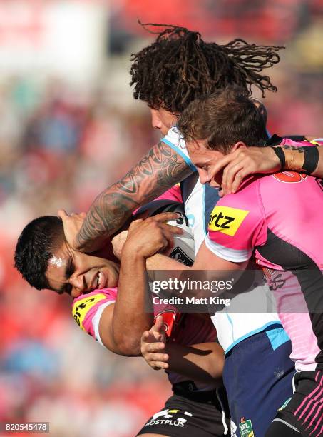 Kevin Proctor of the Titans puts a fend on Tyrone Peachey of the Panthers during the round 20 NRL match between the Penrith Panthers and the Gold...