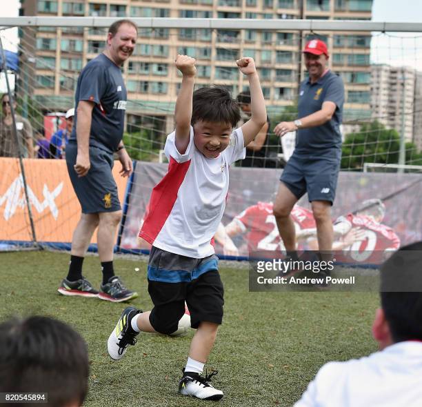 Child celebrating after scoring past Gary McAllister legend of Liverpool during a soccer school on July 22, 2017 in Hong Kong, Hong Kong.