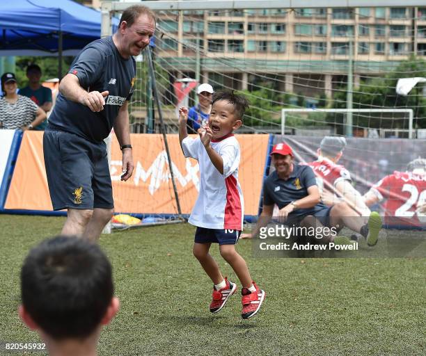 Child celebrating after scoring past Gary McAllister legend of Liverpool during a soccer school on July 22, 2017 in Hong Kong, Hong Kong.